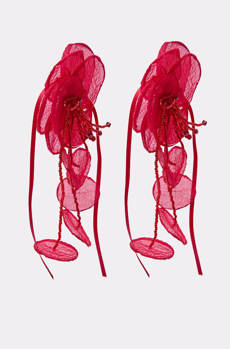 Two large, intricate red SIPPIN WINE EARRING accessories with sheer organza petal layers, long ribbon-like strands, and decorative beads are displayed against a light grey background. 3