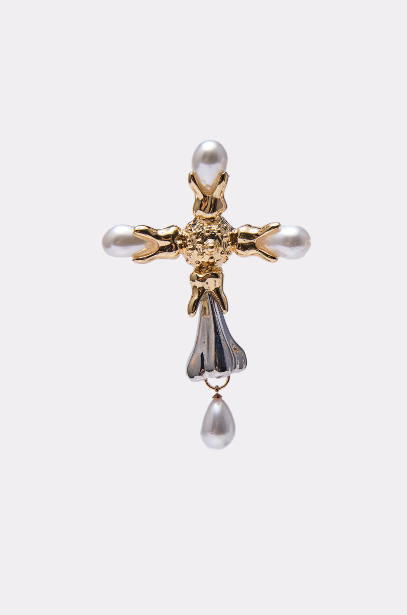 The MILAN EARRING features ornate metalwork and a smooth, reflective finish, adorned with faux pearls at each end and one hanging below—a striking piece inspired by classic cross pendant designs. 3