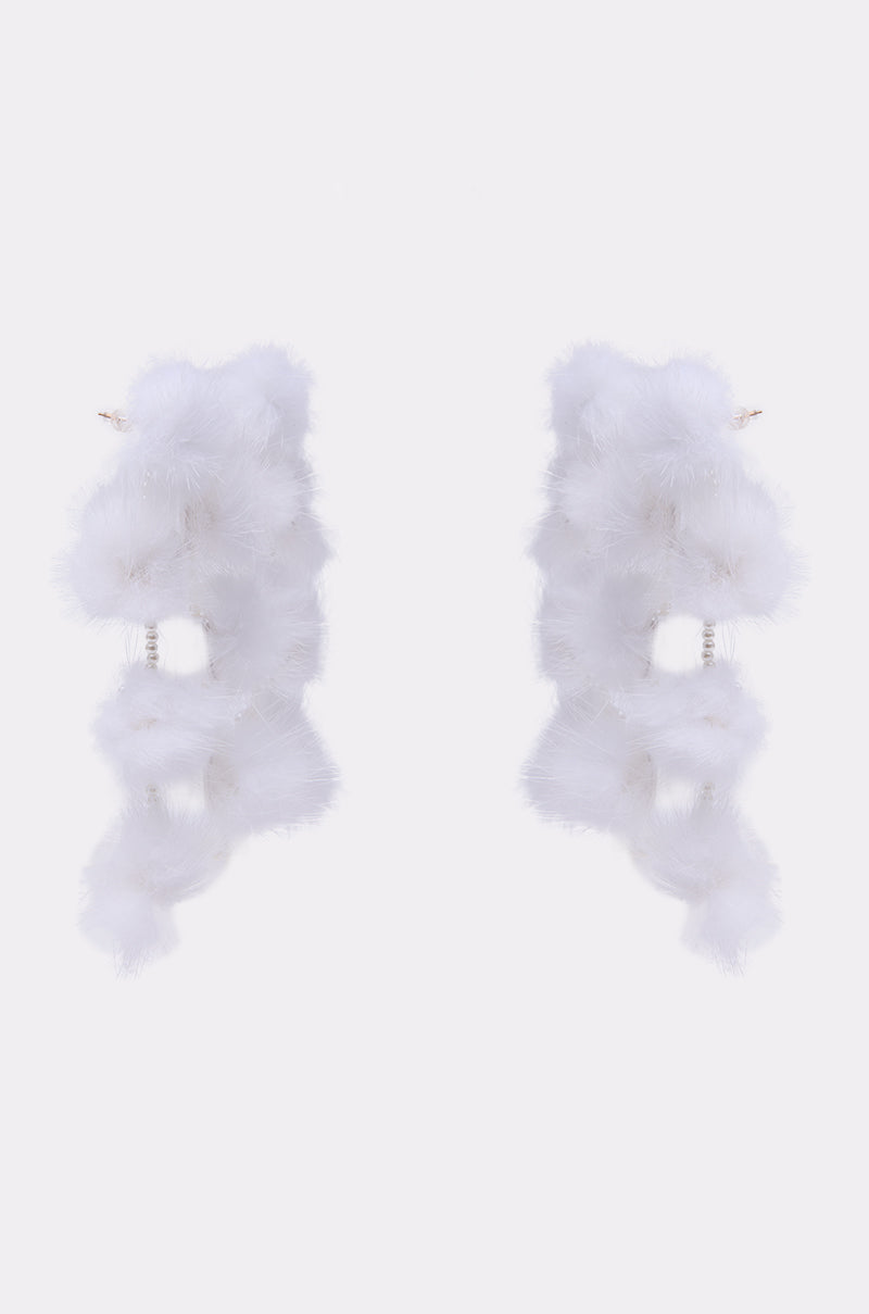 The SNOW PRINCESS EARRING features long, dangling winter earrings with vertically arranged fluffy white pom-poms, displayed against a plain white background. 3