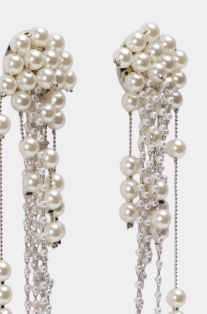 Close-up of the DRIPPIN IN PEARLS EARRING, showcasing clustered white pearls at the top with cascading silver chains and smaller pearls—an eye-catching statement piece, perfect for any special occasion, set against a plain white background. 4