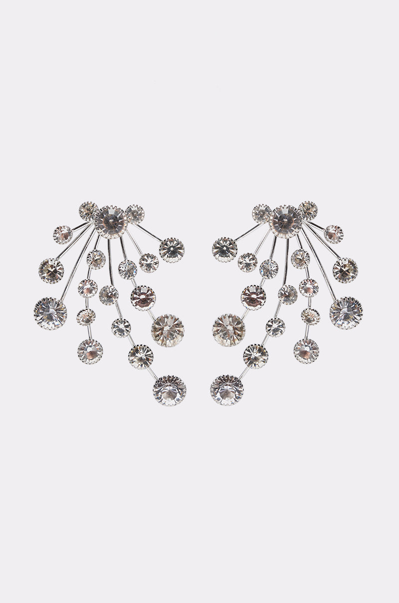 The CLUSTER EARRING features a silver design of radiating spokes, each tipped with a clear round gemstone, creating a fan-like, cascading effect against a plain white background.