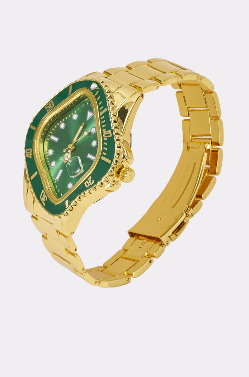 Introducing the CLOCKING TIME WATCH: a luxurious gold statement timepiece featuring a striking green face and bezel, complemented by a sleek metal link band and displayed elegantly against a light gray background.