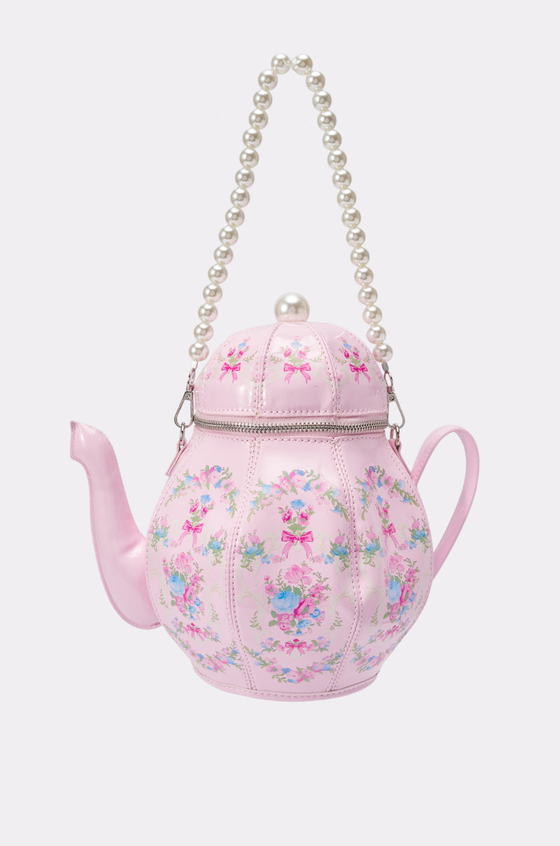 Introducing the TEACUP PARTY BAG: a pink floral novelty handbag styled like an ornate vintage teapot, featuring a pearl-like top handle, silver zipper detail, and elegant floral pattern for whimsical charm.