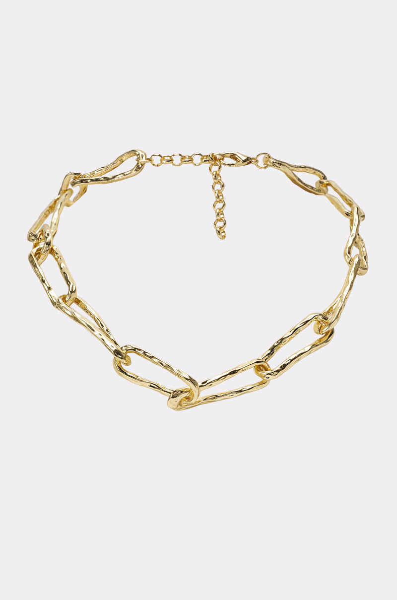 The ORGANIC LINK NECKLACE IN GOLD is a minimalist gold necklace with large, textured oval links and an adjustable clasp, displayed on a plain white background.