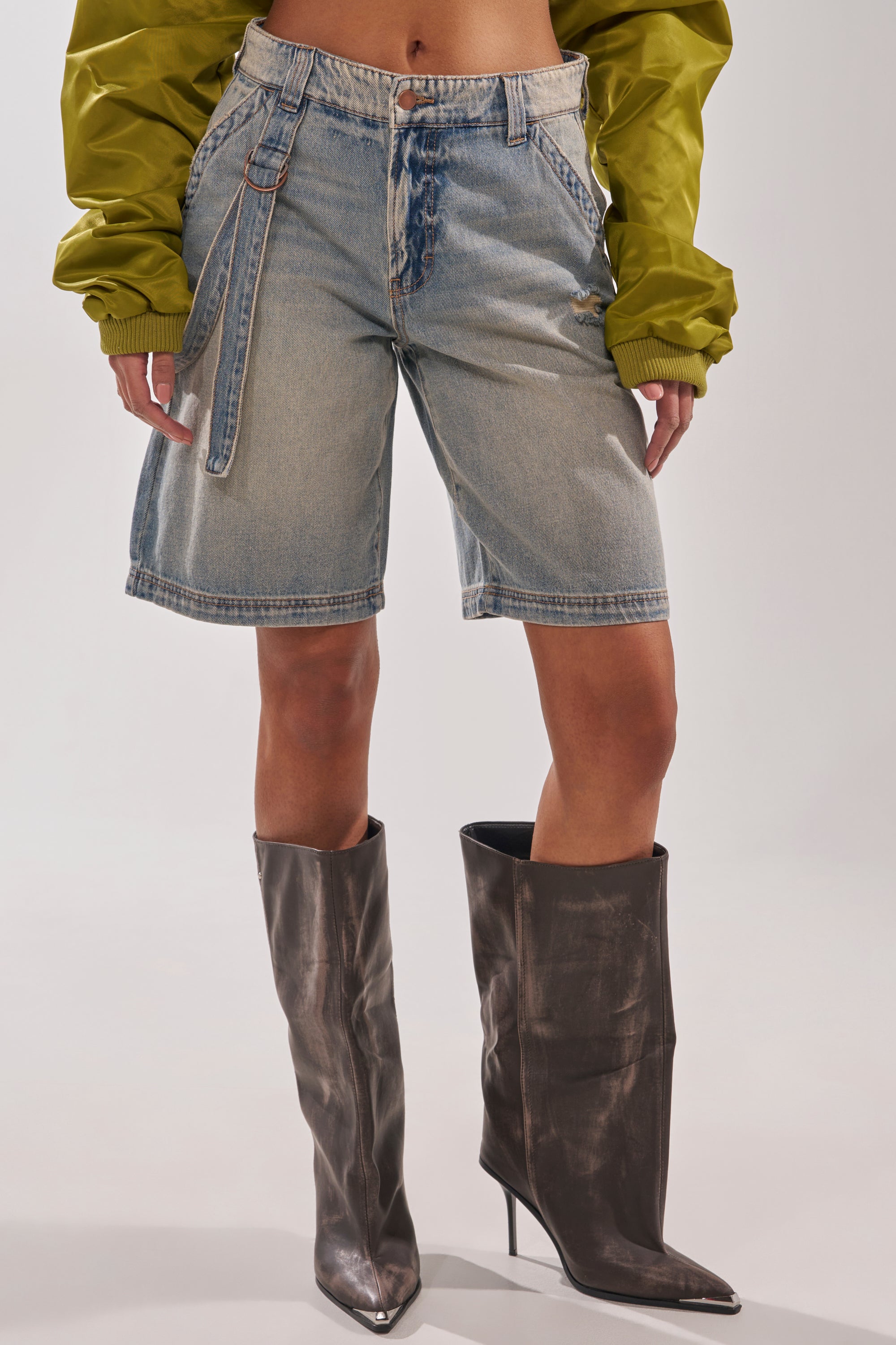 Someone wearing BABY ITS YOU DENIM SHORT paired with boots. 1