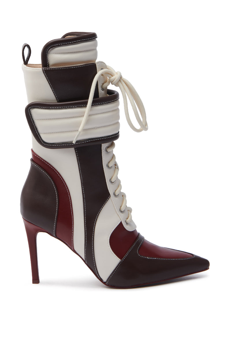 The AZALEA WANG AMADA BROWN SPORTY STILETTO BOOTIE features a high-heeled stiletto with a pointed toe, boasting a color-blocked design in white, brown, and dark red faux leather panels. It showcases a lace-up style, chunky ankle strap, and sleek slim heel.