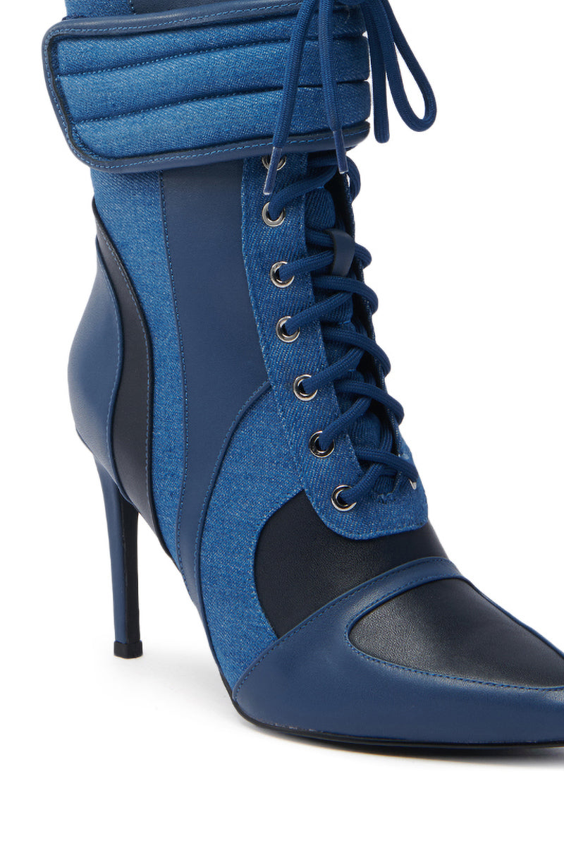 The AZALEA WANG AMADA DENIM SPORTY STILETTO BOOTIE is a chic, stylish boot featuring leather and denim textures. It has a pointed toe, lace-up front with black laces, metal eyelets, and a quilted collar detail. The slender stiletto heel adds flair to its fashionable design. 7