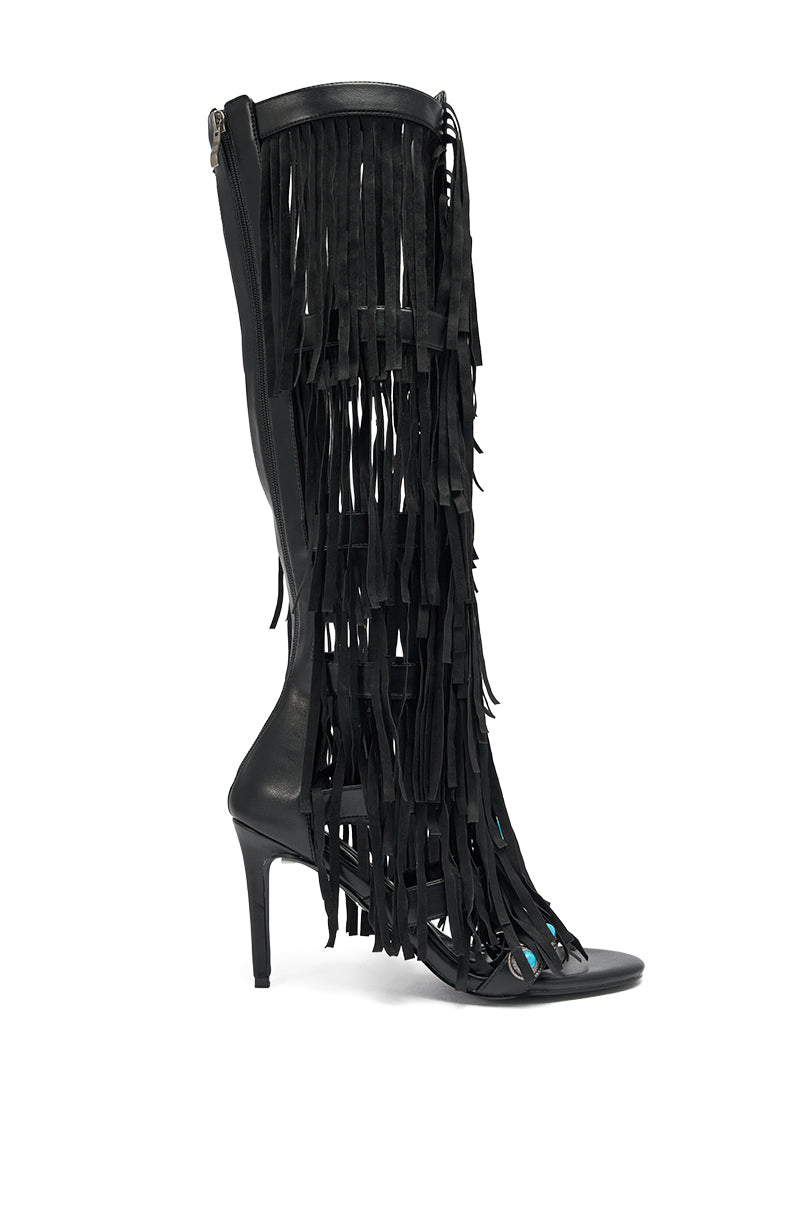 The AZALEA WANG AMADEO BLACK FRINGE AND TURQUOISE GLADIATOR STILETTO SANDAL is a tall, black, open-toe sandal featuring decorative long black fringe strips down the front and sides for standout style. 4