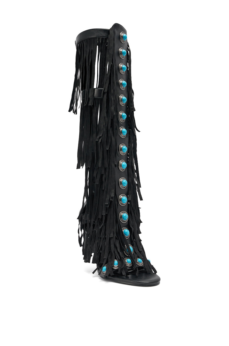 The AZALEA WANG AMADEO Black Fringe and Turquoise Gladiator Stiletto Sandal features multiple layers of black fringe and a row of turquoise conchos up the front. 5