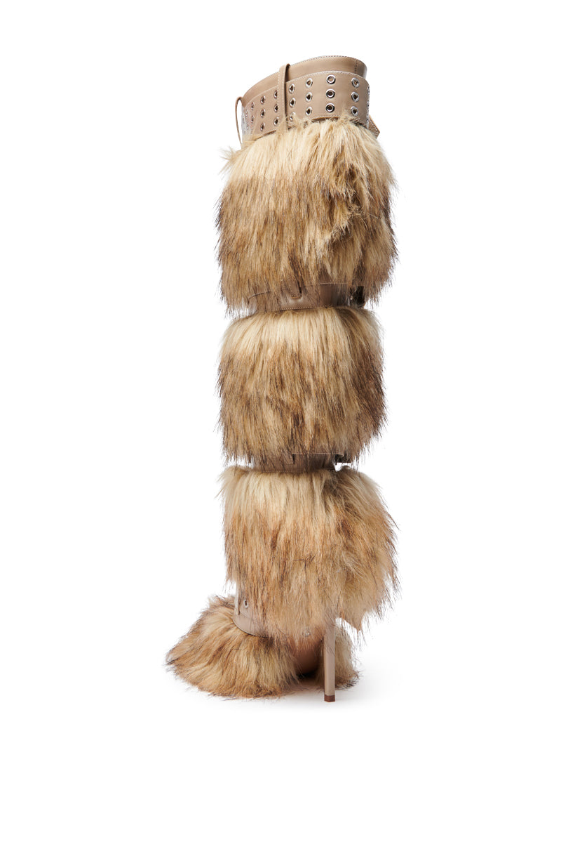 The AZALEA WANG AMALBERT BROWN MULTI FUR AND BUCKLES BOOT showcases bold, fashion-forward style with thick brown faux fur panels, tan leather upper, metal eyelets, laces, buckles, a stiletto heel, and a knee-high shaft for dramatic flair.
