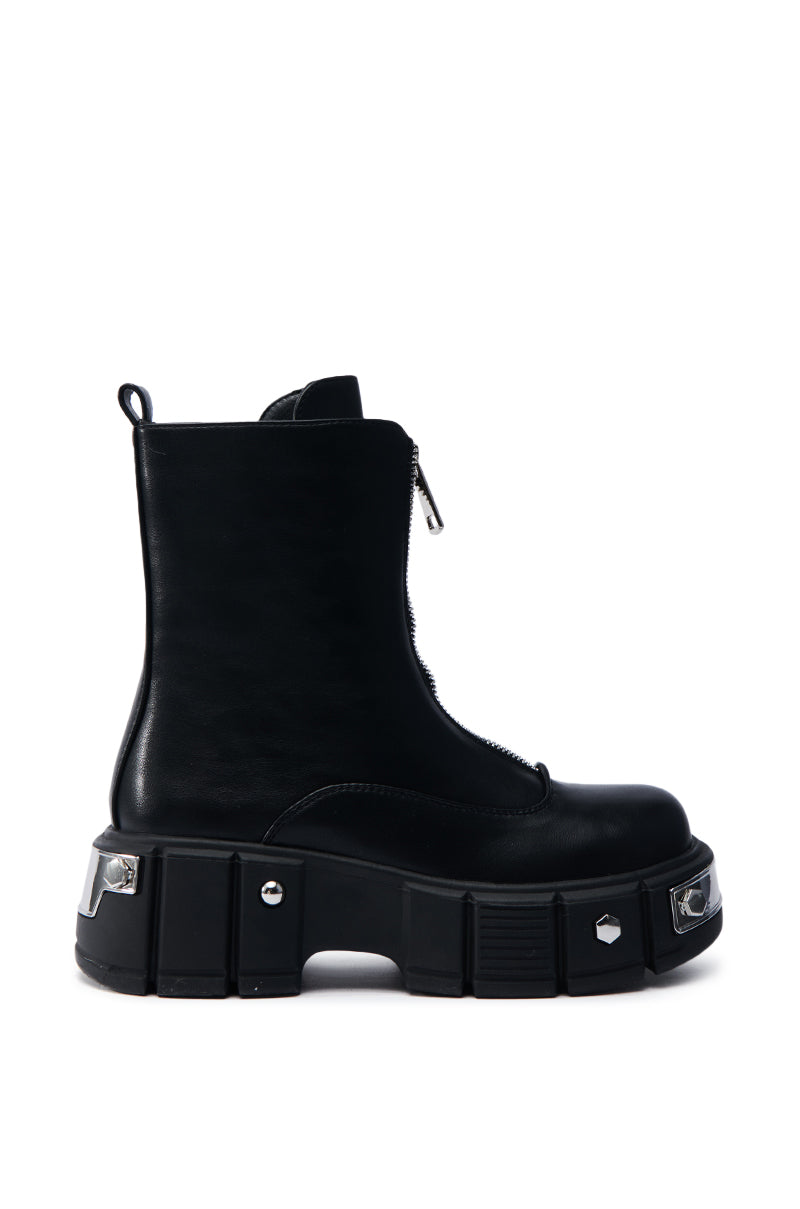 The AZALEA WANG AMARANTA BLACK BOOTIE features a chunky platform lug sole, silver stud accents, a front zipper, and a back loop for easy wear. Its angular design gives it a modern and bold look in black faux leather.