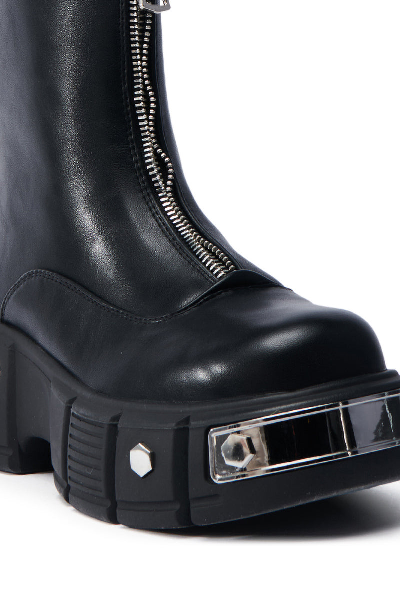 Close-up of the AZALEA WANG AMARANTA BLACK BOOTIE, featuring a faux leather design with a chunky heel, prominent front zipper, decorative hexagonal metal studs, and a reflective silver strip on the platform lug sole's front edge.