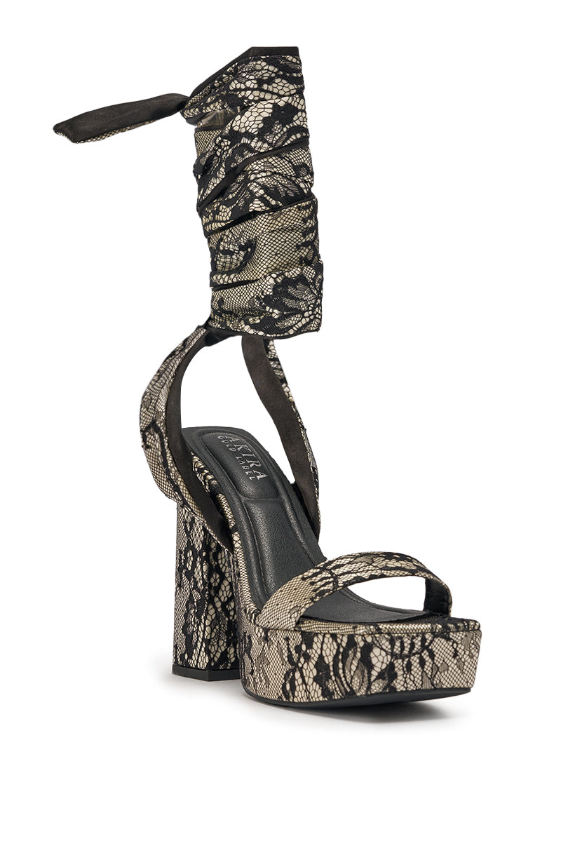 The AKIRA GOLD AMBROISINE Black Lace Strappy Chunky Sandal features a block heel, platform, black and beige lace pattern, and wide ankle wrap tie—ideal for fans of lace up heels. 6