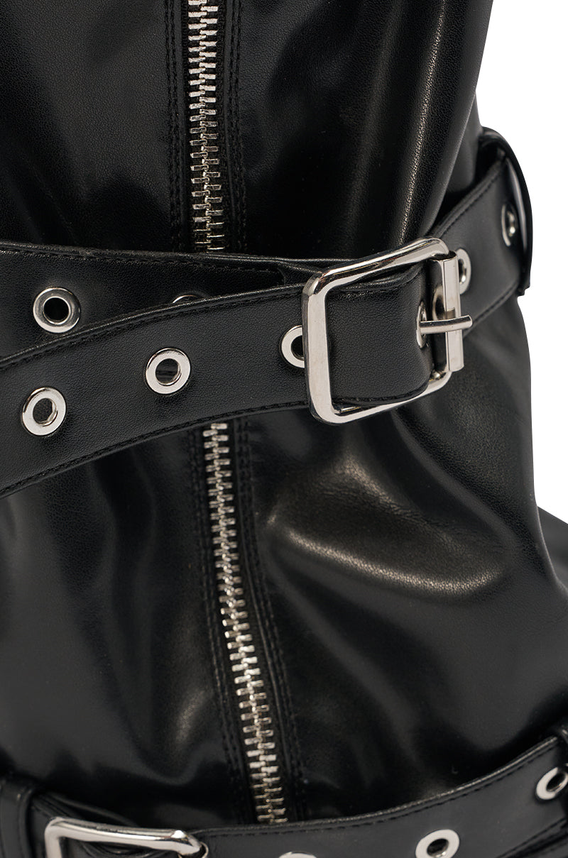 Close-up of the AZALEA WANG AMES BLACK PU HARDWARE EMBELLISHED STILETTO BOOTIE, a shiny black faux leather mid-calf bootie with a silver zipper, buckle strap, and metal eyelets. 6
