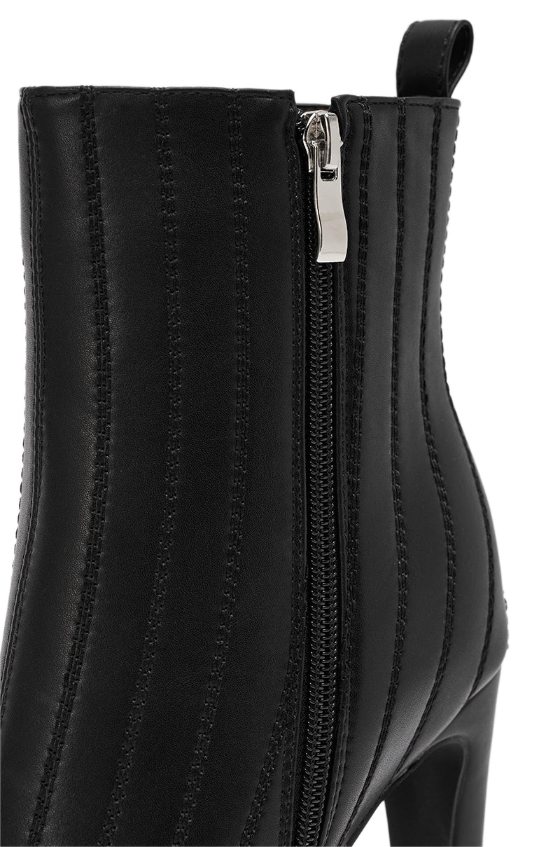 Close-up of the AZALEA WANG AMHERST BLACK PU BOOTIE, featuring vertical stitched details, a silver side zipper, chunky heel, and a fabric pull tab at the back for easy wear.