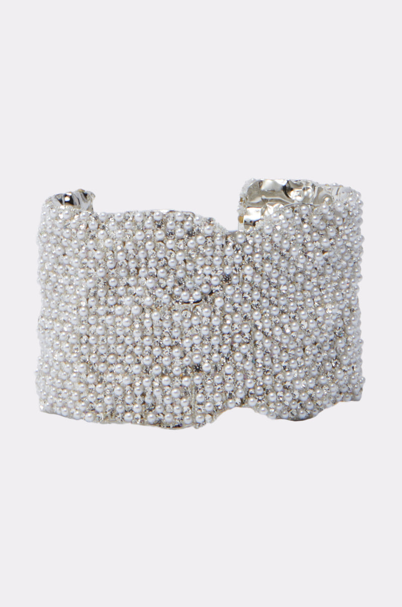 The CATCHING FLIGHT BRACELET is a wide silver bracelet adorned with rows of shiny, rounded beads, featuring a textured, sparkling surface, slightly uneven edges, and a reflective metallic finish.