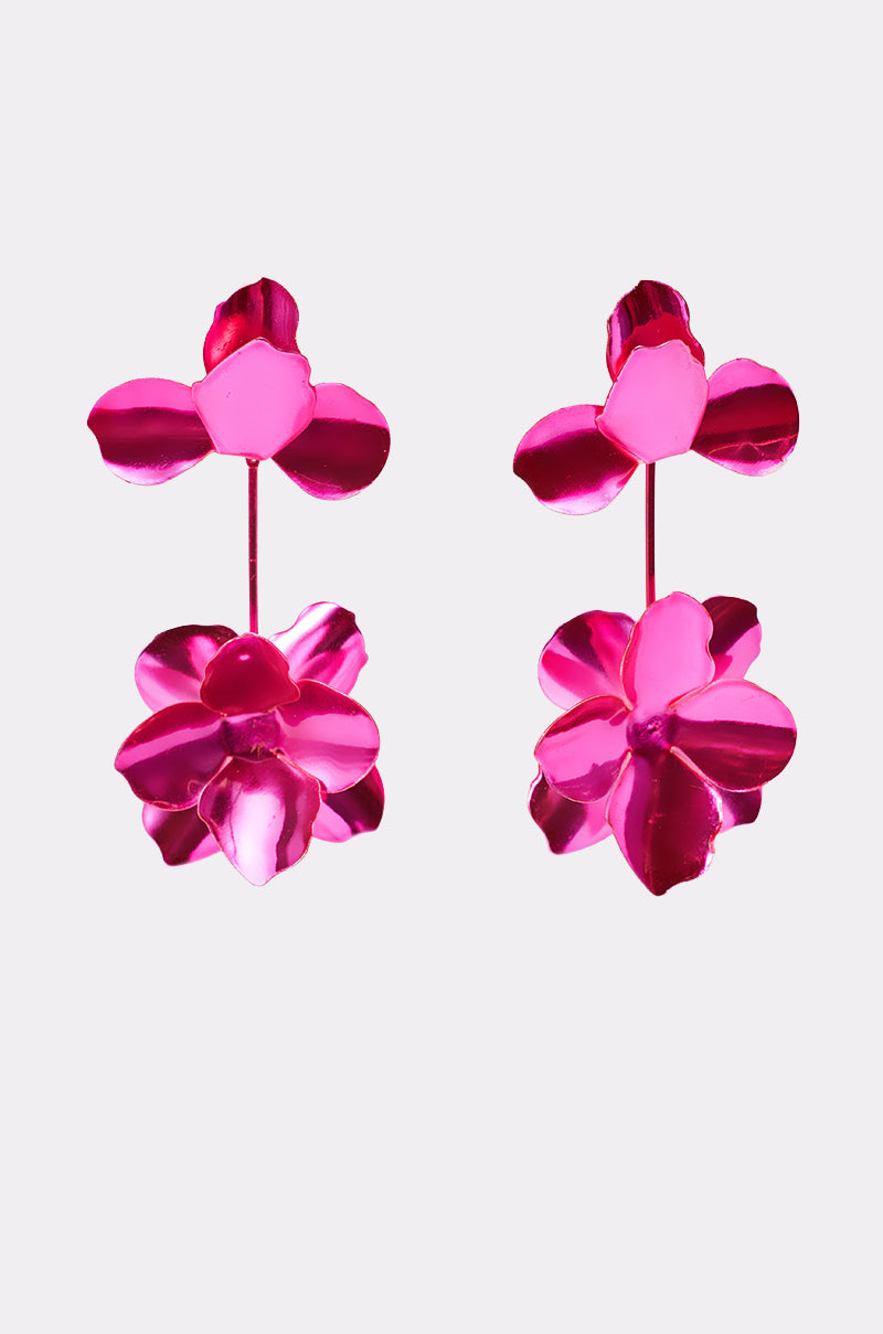The ASH FLOWER EARRING features two vibrant metallic hot pink earrings with a double-flower layered petal design, displayed on a plain white background. 1