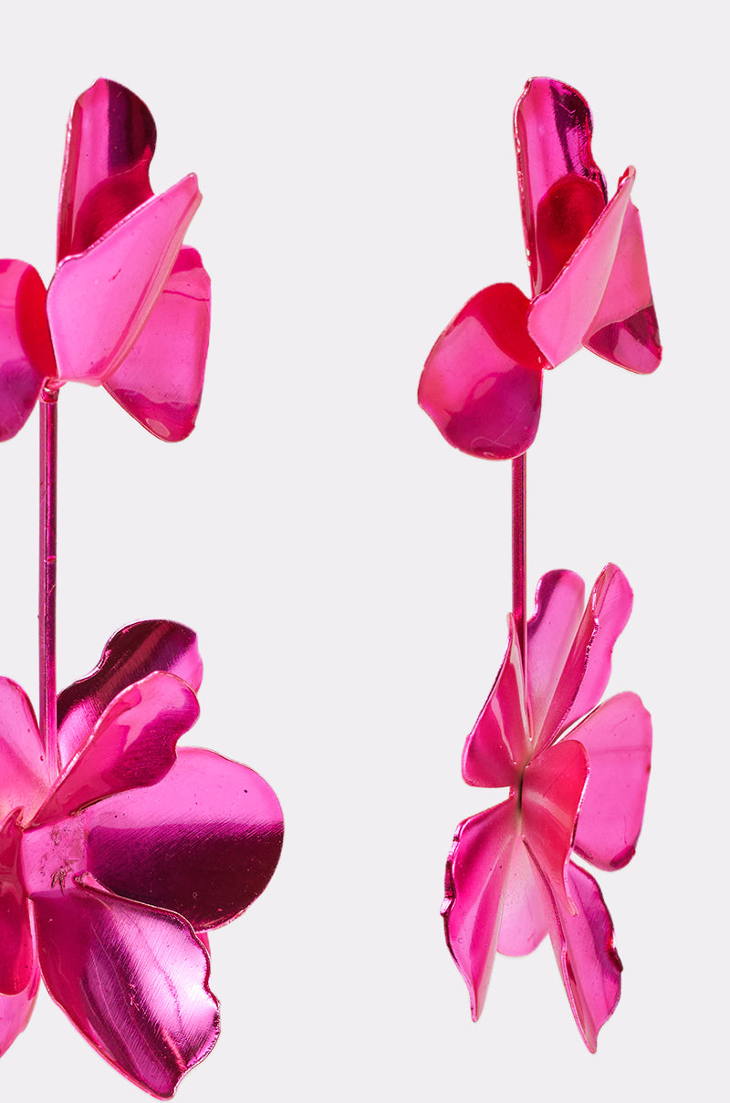 Close-up of the ASH FLOWER EARRING in hot pink, showcasing a double-flower design with layered petals and a shiny finish, displayed against a plain white background. 4