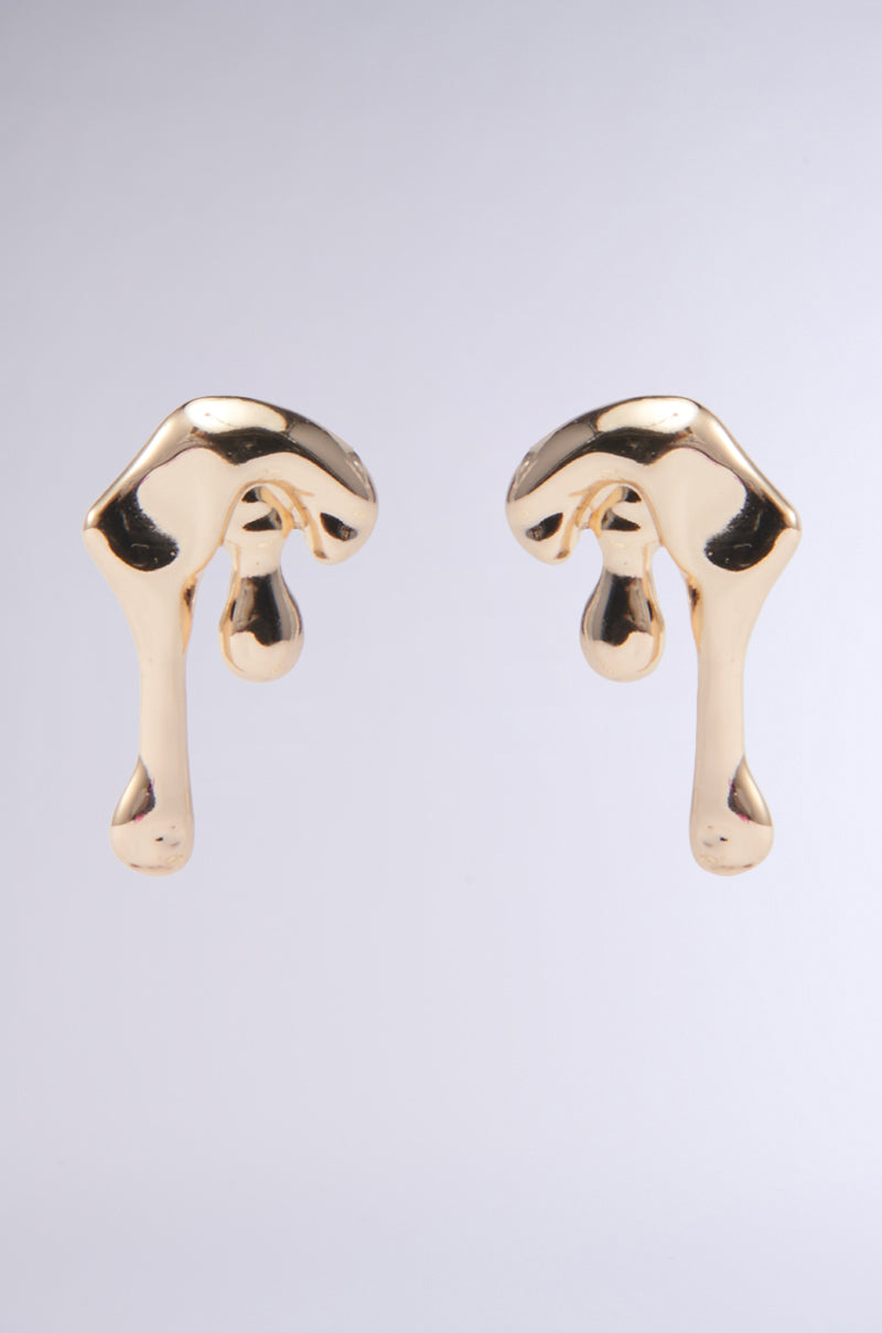 Drippy Earrings feature an abstract faux gold design with smooth curves and droplet-like extensions against a plain gray background.