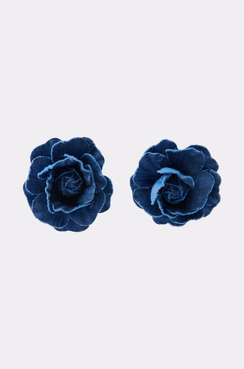 Two DENIM BLUE EARRING pieces, each featuring layered blue fabric petals resembling indigo denim, are displayed side by side on a plain white background. 0