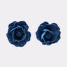 Two DENIM BLUE EARRING pieces, each featuring layered blue fabric petals resembling indigo denim, are displayed side by side on a plain white background.