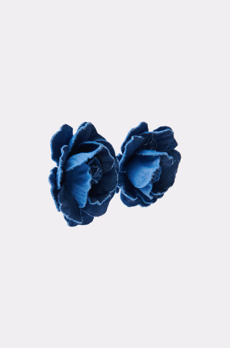 Two DENIM BLUE EARRINGs with layered fabric petals, resembling floral studs, are displayed side by side on a plain white background. 2