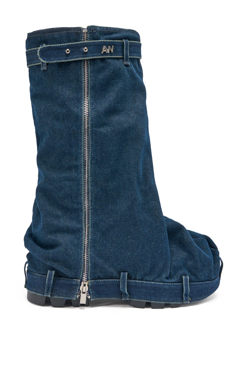 The AKIRA GOLD ANGELA FOLD OVER PLATFORM BOOT IN DARK DENIM is a large, slouchy denim boot with a front zipper, chunky lug sole, and strap accents at the top and bottom. 4