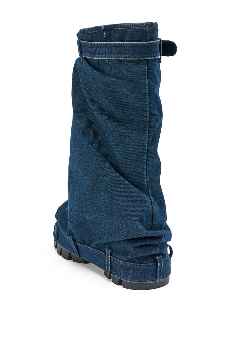 The AKIRA GOLD ANGELA Fold Over Platform Boot in dark denim features a slouchy foldover design, chunky lug sole, and top strap, shown from the back left side against a white background. 6