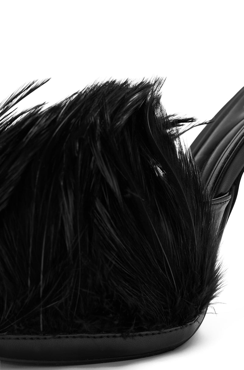 Close-up of the AZALEA WANG ANGELES BLACK FEATHER STILETTO SANDAL, featuring a fluffy feather upper and smooth vegan leather on the side and platform heel.