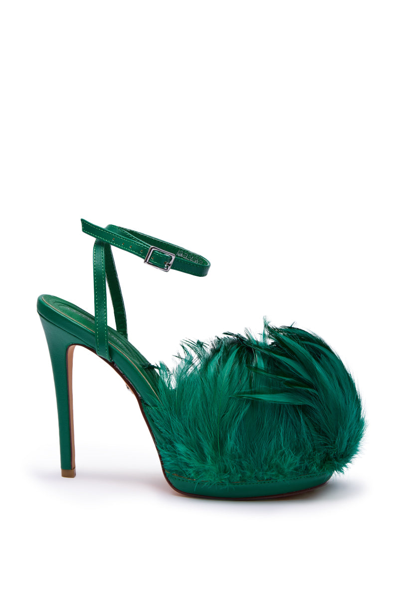 The AZALEA WANG ANGELES GREEN FEATHER STILETTO SANDAL features green feathers on the front and sides, a faux leather finish, an ankle strap, and a slim stiletto heel for a bold, stylish look.