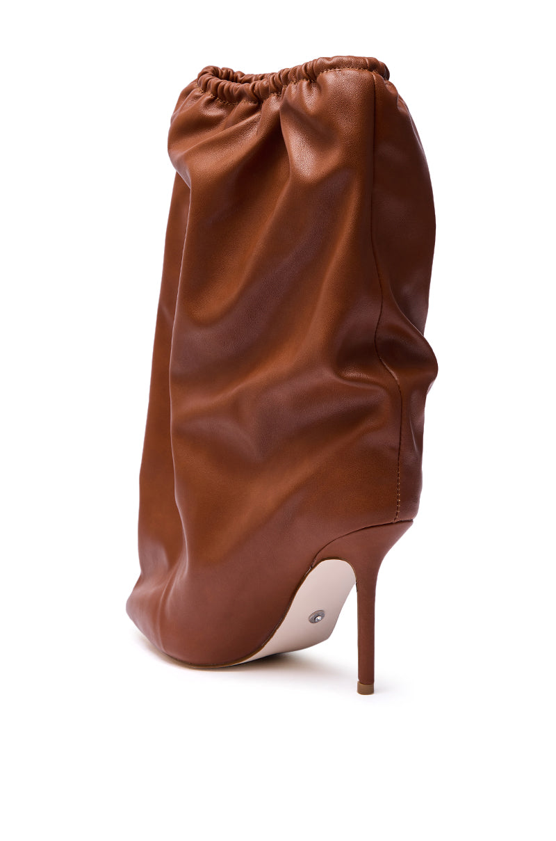 The AZALEA WANG ANNEKE Tan Ruched Topline Stiletto Bootie features a gathered leather upper and pointed toe, shown from the back on a white background.