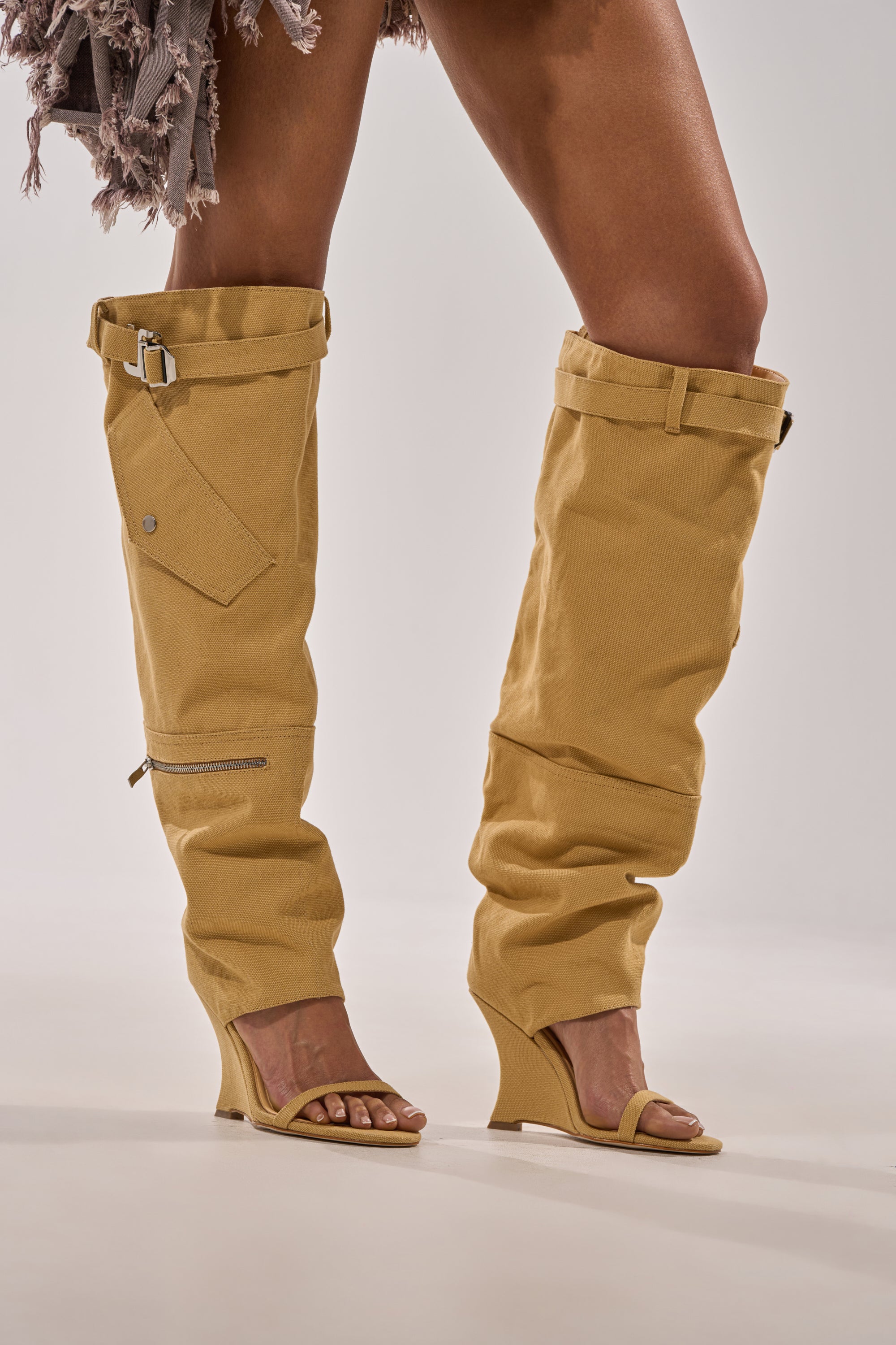 Wearing the AZALEA WANG ANOUK KHAKI SPORT WEDGE BOOT with a fringed skirt and bold accessories creates a standout street style look. 2