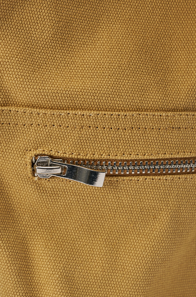 Close-up of a metal zipper on the textured khaki fabric of the AZALEA WANG ANOUK KHAKI SPORT WEDGE BOOT, partially closed to reveal the distinctive woven pattern. 6