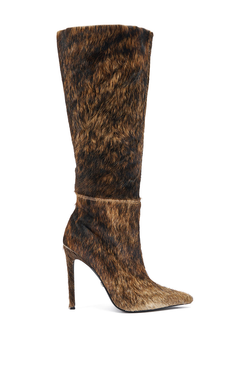 The AZALEA WANG ANSEL BROWN COW HAIR STILETO BOOT is a knee-high, pointed-toe stiletto with a brown and black faux-fur animal print, shown in side profile against a white background.