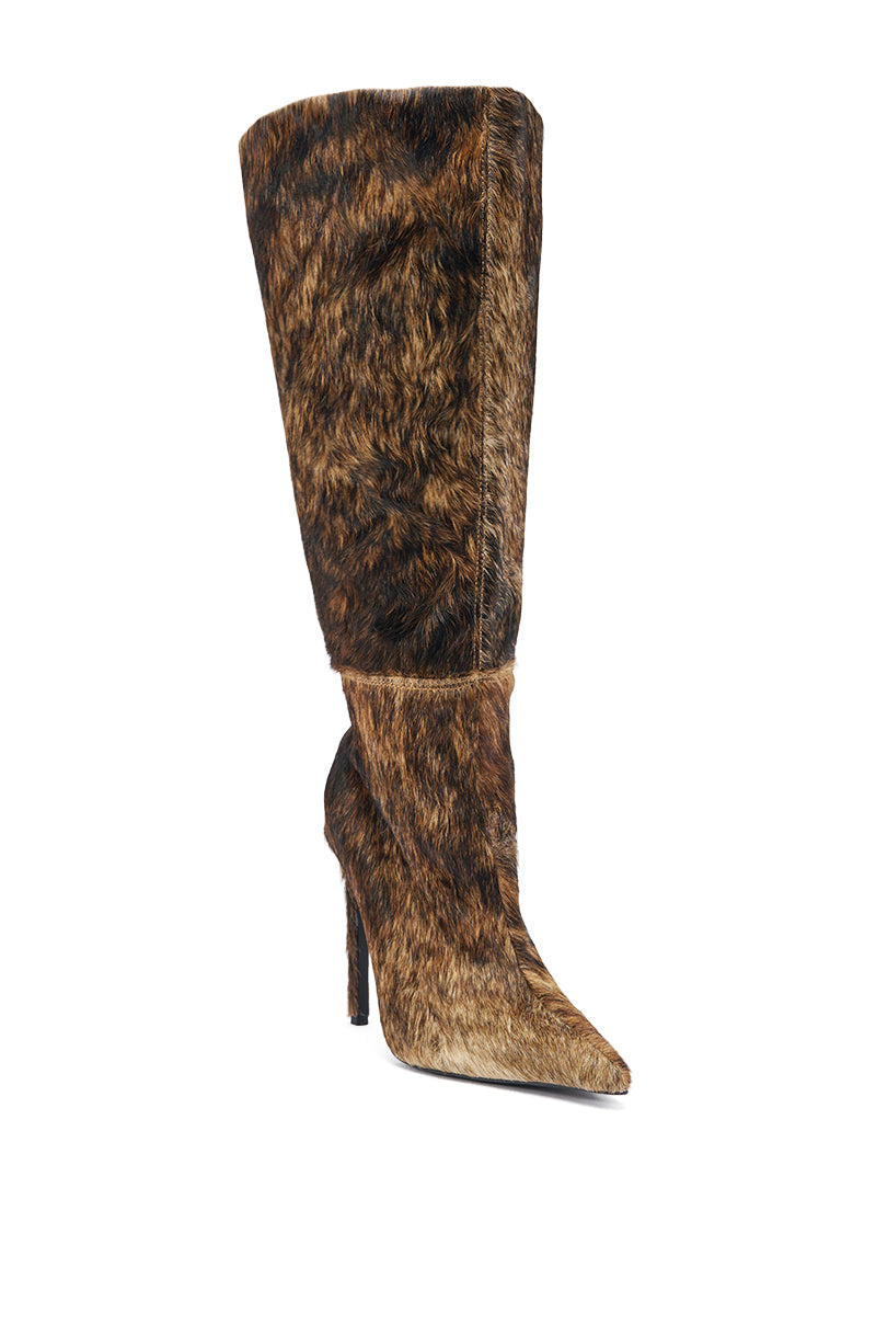 The AZALEA WANG ANSEL BROWN COW HAIR STILETTO BOOT is a knee-high, pointed toe stiletto boot covered in brown faux fur with light and dark shades for a textured, animal-inspired cow hair look.