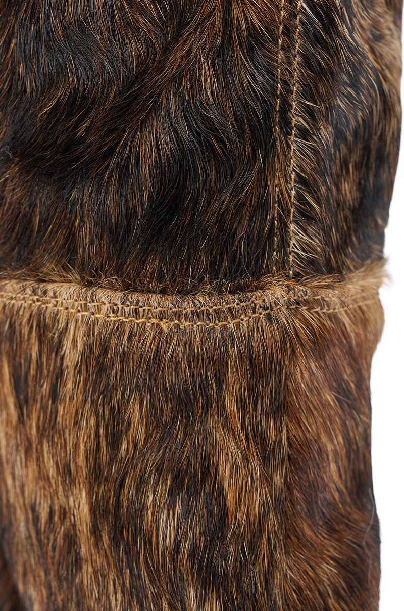 Close-up of brown and black faux fur fabric with visible stitching and a horizontal seam, mirroring the luxurious look of the AZALEA WANG ANSEL BROWN COW HAIR STILETTO BOOT.