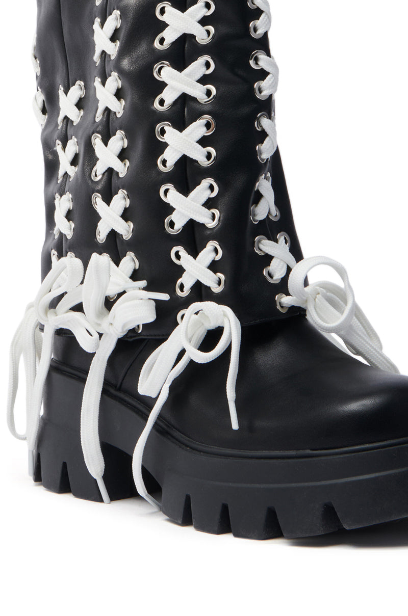 The AZALEA WANG ANSELM BLACK LACE TIE BOOTIE features a sleek faux leather design, black color, thick white laces through silver eyelets tied in large bows, and is completed with a chunky heel and rugged sole for an edgy yet sophisticated look.