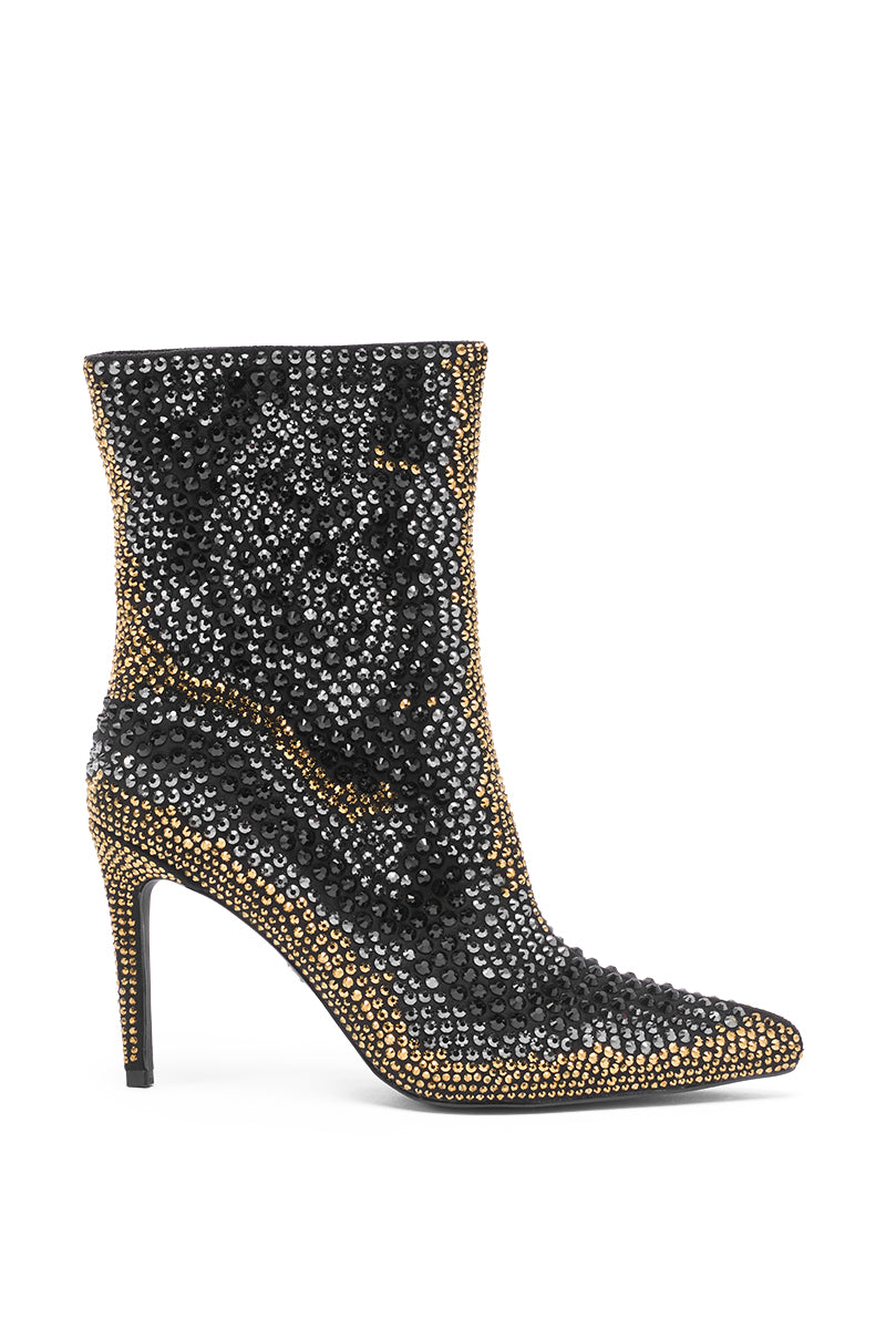 The AZALEA WANG ANSLEY BLACK MULTI RHINESTONE COCKTAIL BOOTIE is a striking ankle bootie with black and gold rhinestones, a pointed toe, stiletto heel, and an elegant design perfect for any cocktail event.
