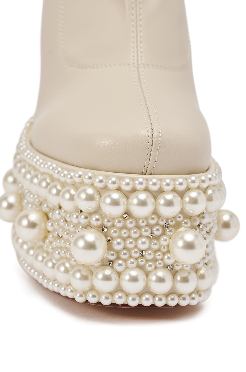 Close-up of the AZALEA WANG ANTARIS Beige Pearl Detail Platform Bootie, a cream faux leather style with chunky heel, thick sole, and various imitation pearls and silver beads embellishing the front. 8