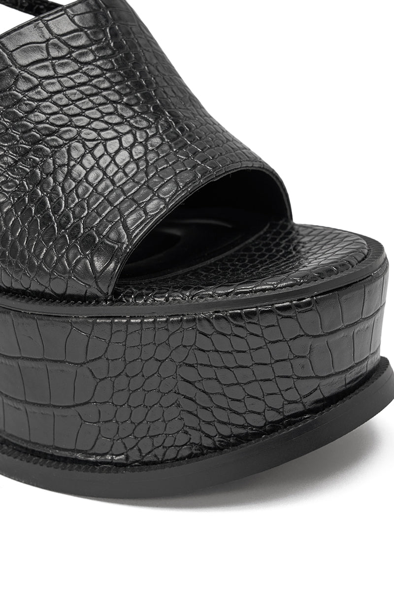 Close-up of the AZALEA WANG ANTHELMINE BLACK CROC PLATFORM SANDAL, showcasing its black crocodile-embossed faux leather, open toe, thick sole, and stylish block heel. 6