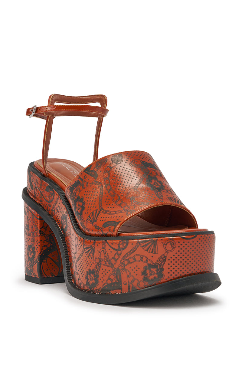 The AZALEA WANG ANTHELMINE COGNAC PLATFORM SANDAL features tattoo detailing, an open toe, adjustable ankle strap, cushion insole for all-day comfort, and a stylish chunky block heel in printed brown faux leather. 4