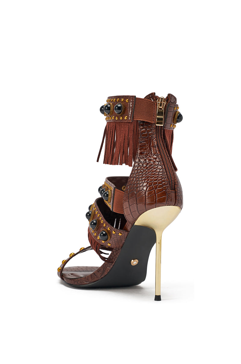 The AZALEA WANG ANTOINE Brown Fringe and Gold Embellished Stiletto Heel features croc-embossed faux leather, a gold heel, fringe ankle strap with gold studs, black gemstone accents, and a handy back zipper. 6