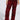 Someone in shredded ON FIRE DISTRESSED DENIM PANT, a red mid-rise design with frayed texture, pairs it with leopard print slip-ons against a plain backdrop. The high-waisted pants offer a stylish look, while the top is partially visible.