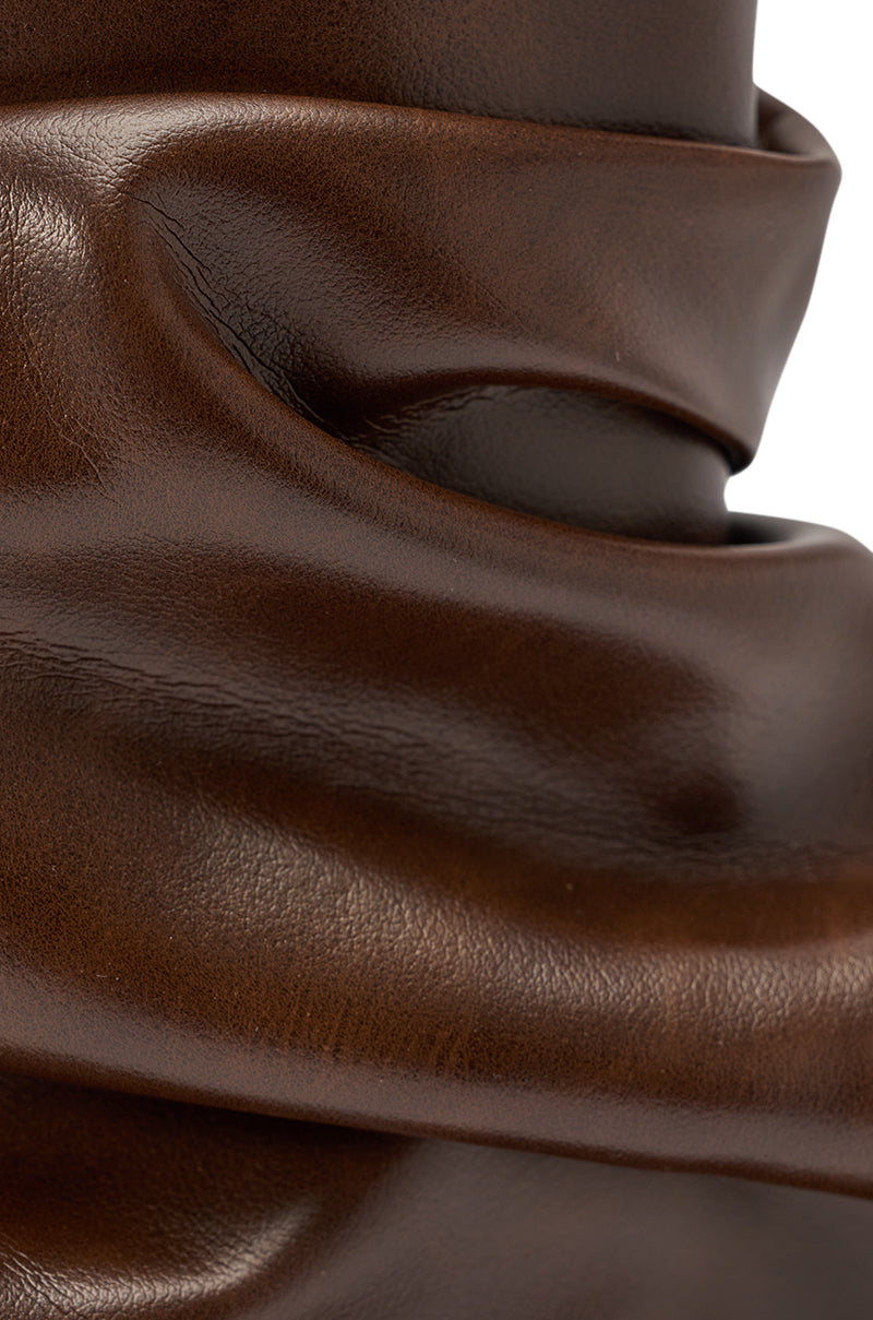 Close-up of the AZALEA WANG APEX BROWN SLOUCHY OPEN TOE BOOTIE’s smooth, glossy chocolate faux leather with gentle folds and creases, highlighting its rich texture and soft sheen. 7
