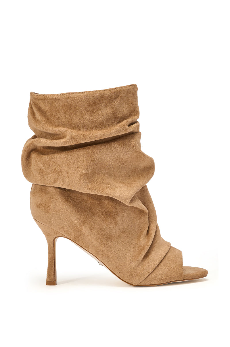 The AZALEA WANG APEX light brown faux suede open toe bootie features a slouchy ankle-high silhouette with a pointed open toe and a thin mid-height heel, shown here on a white background. 4