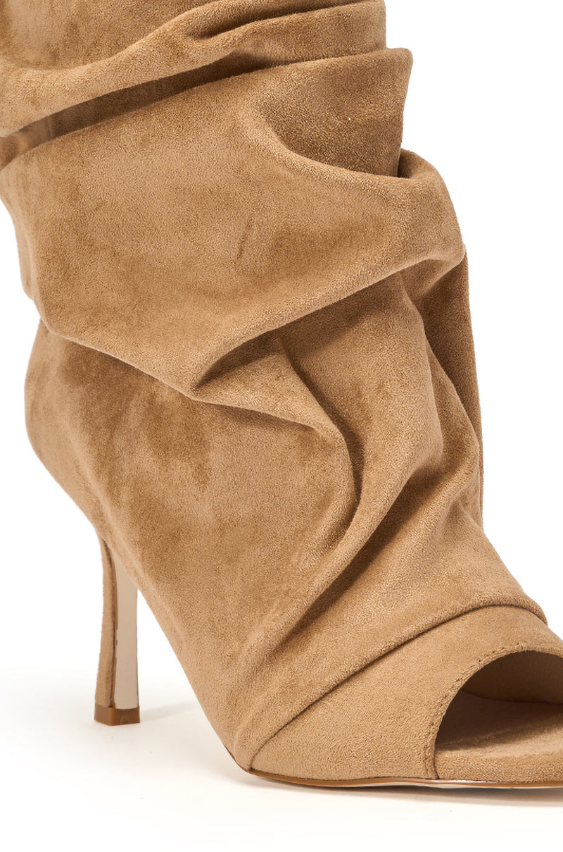 A close-up of the AZALEA WANG APEX LIGHT BROWN FAUX SUEDE OPEN TOE BOOTIE, featuring a tan slouchy design with a pointed toe and stiletto heel, displayed against a white background. 7
