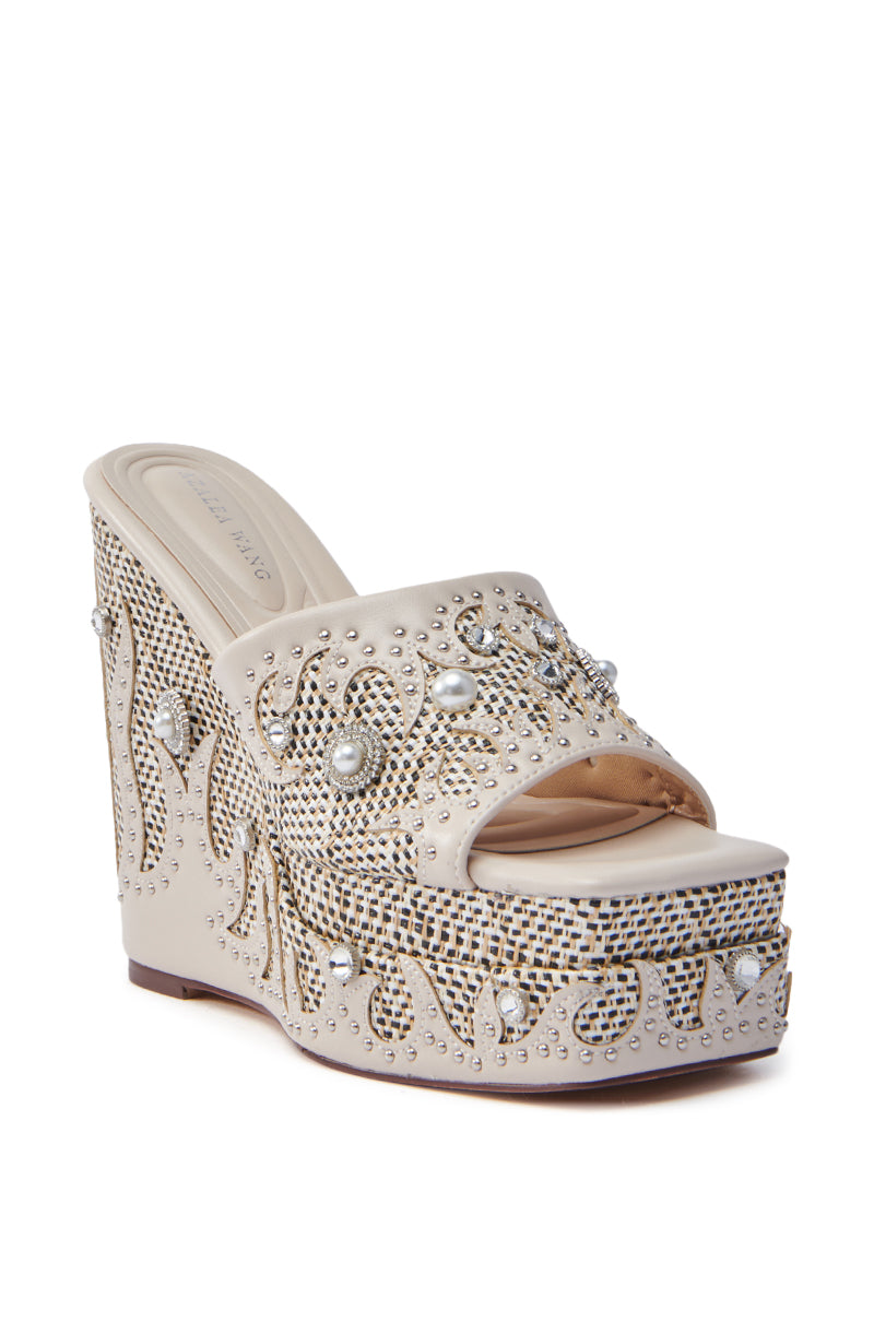 The AZALEA WANG APPOLONIA BEIGE TWEED EMBELLISHED WEDGE SANDAL features an open square toe, intricate embroidery with rhinestones and pearls on a beige base, and a high arch for a statement-making look.