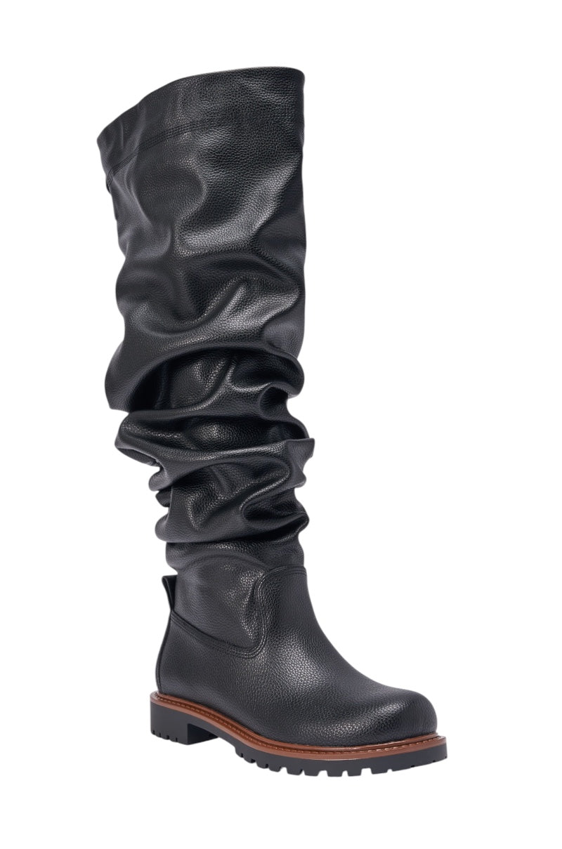 The AZALEA WANG ARDIS BLACK FLAT RUCHED BOOT features a black knee-high slouchy design in textured faux leather, a brown midsole, and rugged treaded sole—ideal for those seeking stylish black boots. 3