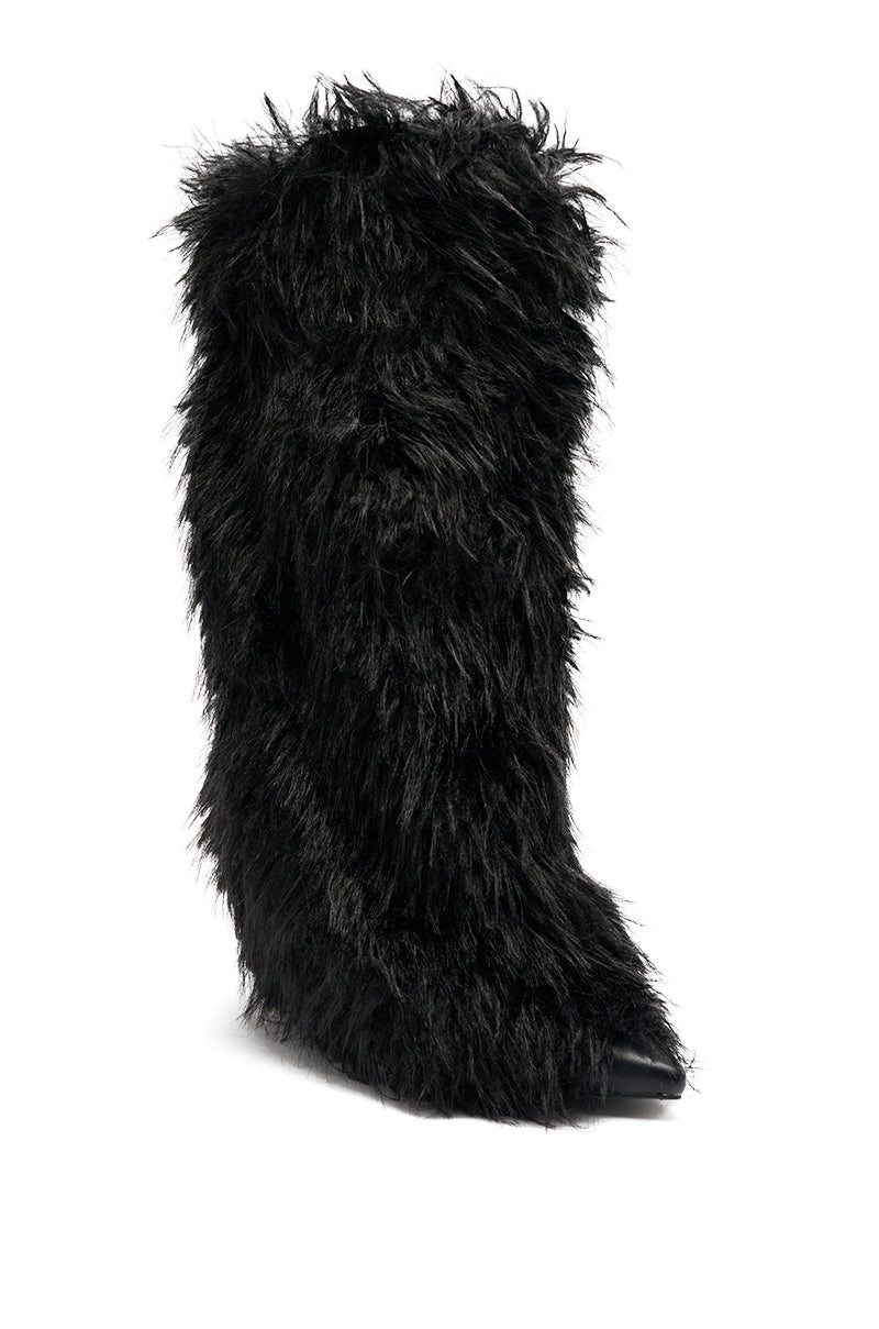 The AZALEA WANG ARETE BLACK FUR STILETO BOOT is a knee-high, pointed-toe stiletto featuring long, shaggy black faux fur and a hidden heel, standing upright on a white background for a bold, modern look.