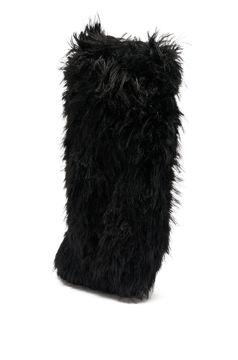 The AZALEA WANG ARETE BLACK FUR STILETTO BOOT, designed in a sleek upright silhouette and covered in long, plush black faux fur, stands against a white background.